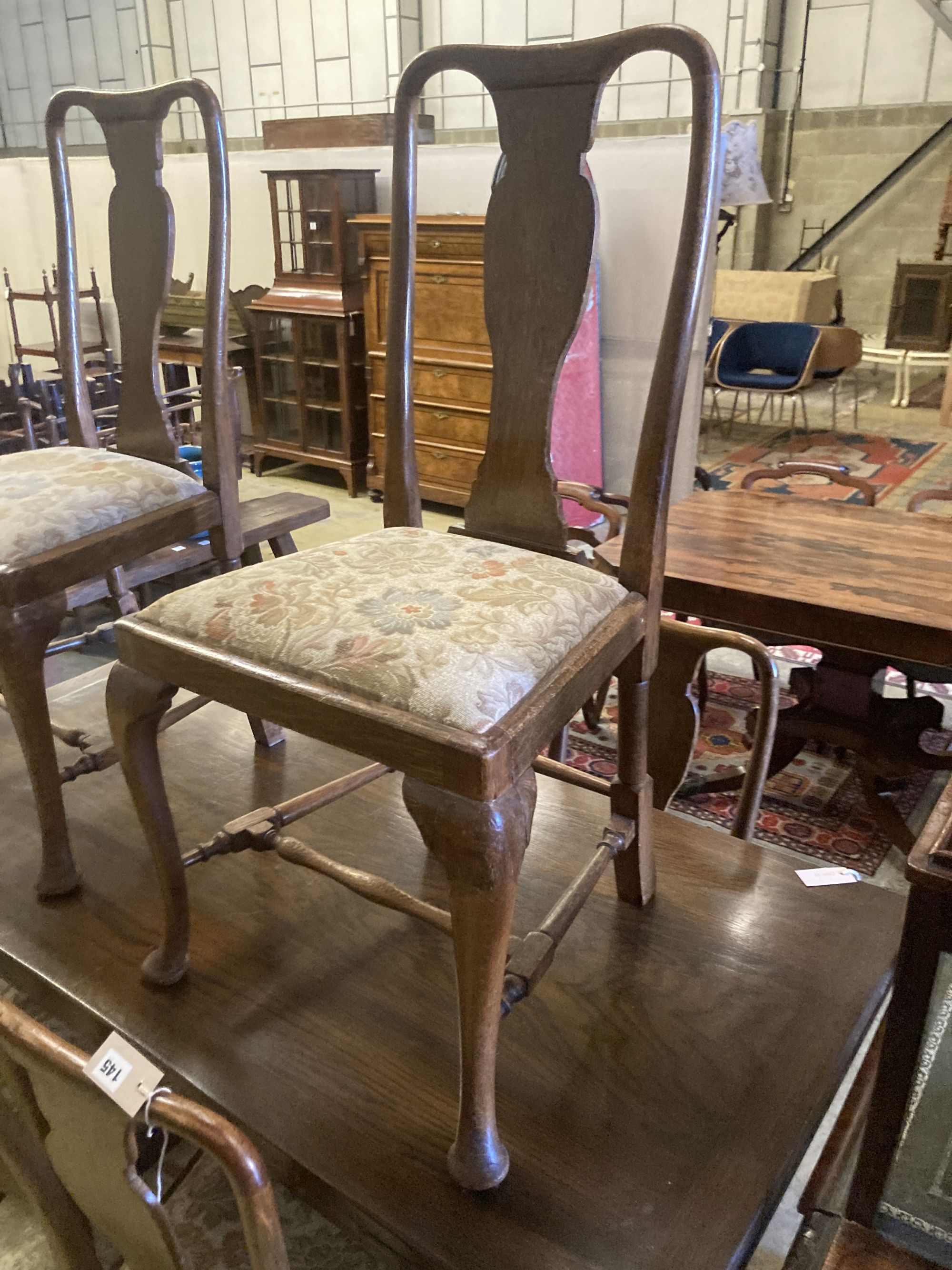 A set of eight 1920s oak Queen Anne-style dining chairs, two with arms
